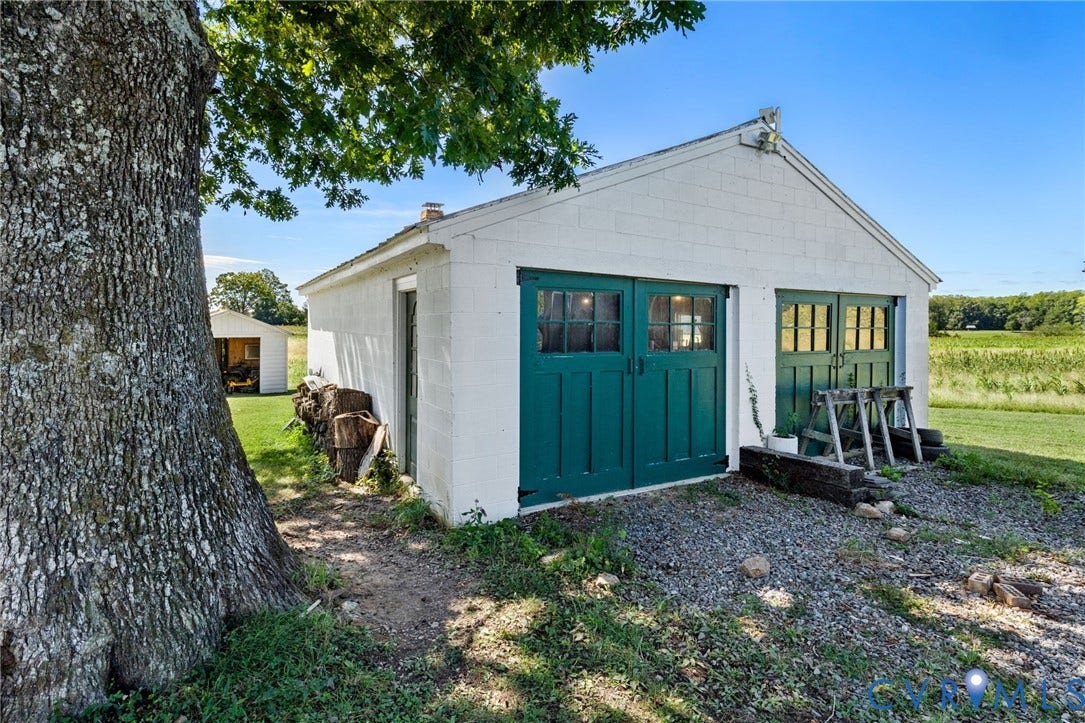 4109 Whitehall Road, Sandy Hook, VA 23153 Detached white garage with two sets of green double doors and window panes