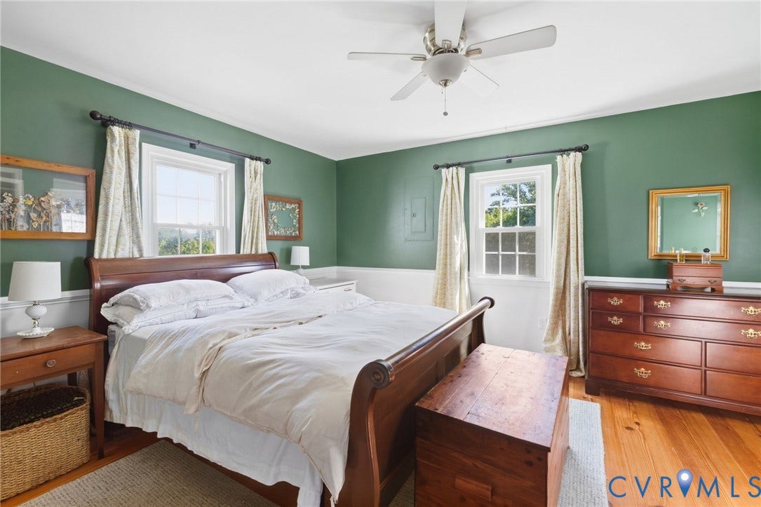 4109 Whitehall Road, Sandy Hook, VA 23153 Hardwood flooring, painted walls, white trim, ceiling fan, and window