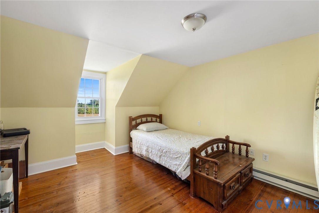 4109 Whitehall Road, Sandy Hook, VA 23153 Hardwood flooring, sloped ceilings, single window with white trim, wall-mounted light fixture