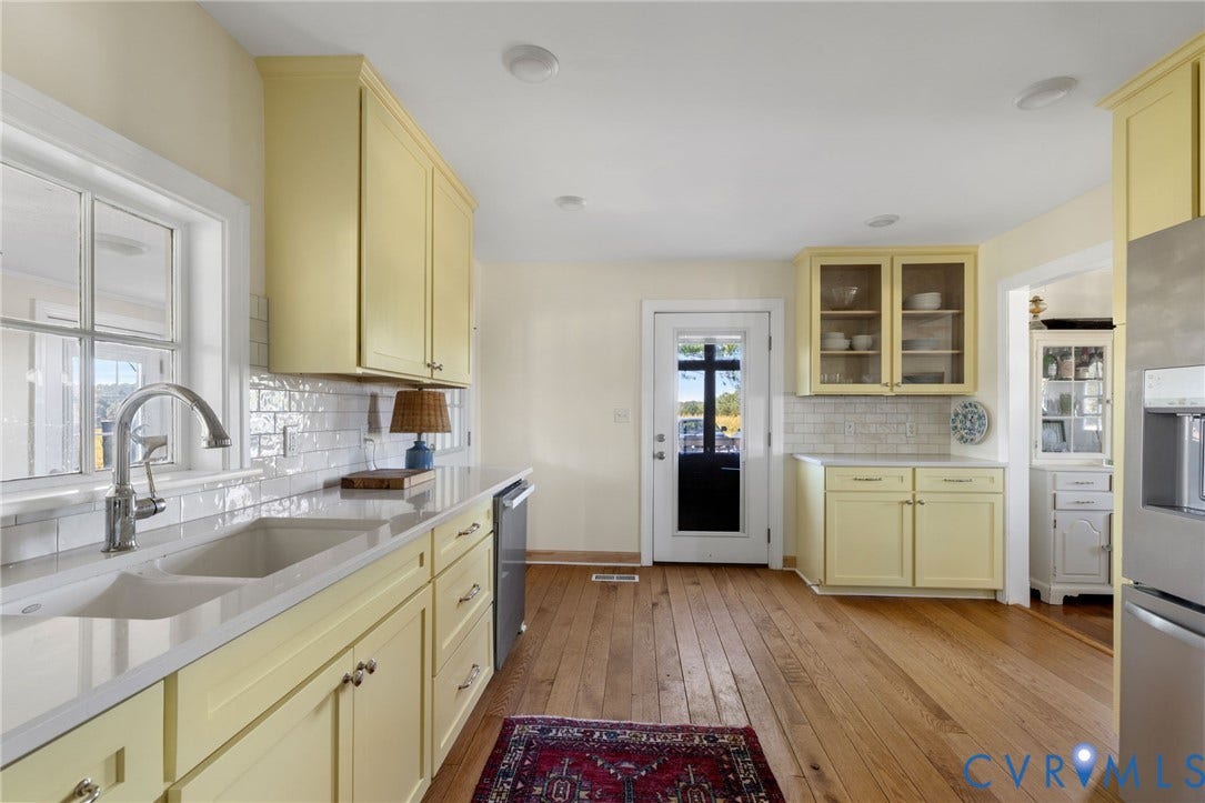 4109 Whitehall Road, Sandy Hook, VA 23153 Kitchen featuring wood-finish flooring, light-toned cabinetry, subway tile backsplash, light-toned countertops, and a double basin sink