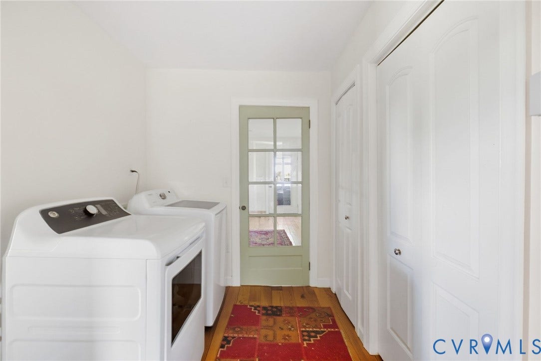 4109 Whitehall Road, Sandy Hook, VA 23153 Hardwood flooring, painted interior door with glass panes, white paneled doors, and white walls