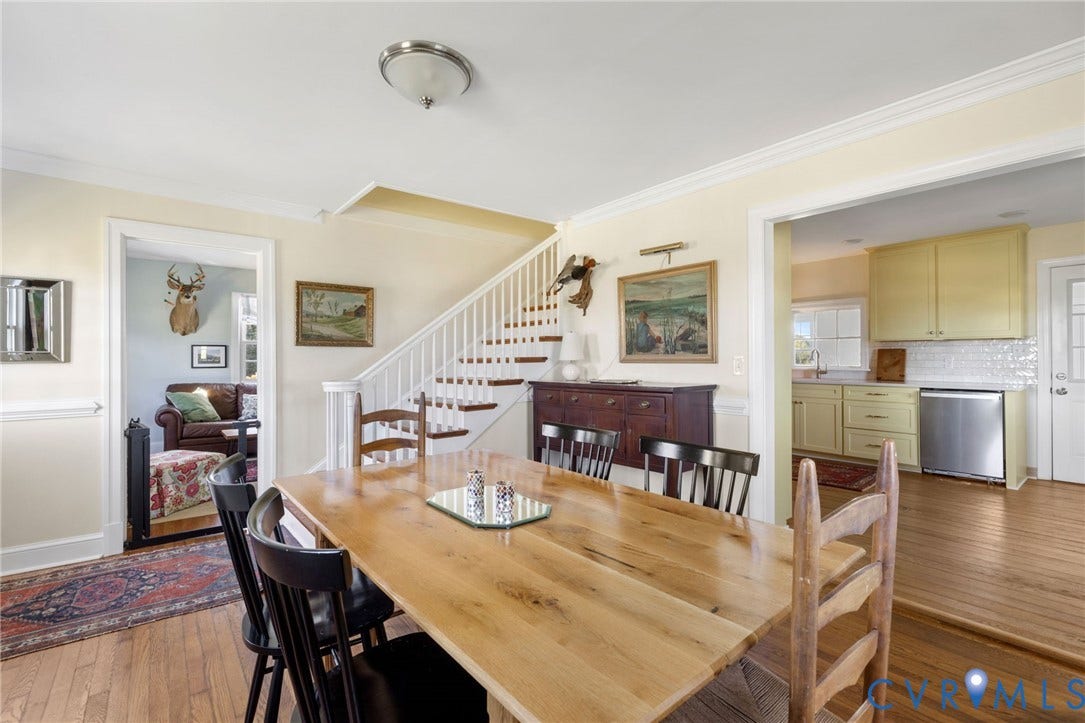 4109 Whitehall Road, Sandy Hook, VA 23153 Dining area with wood-finish flooring, staircase with white risers, and crown molding