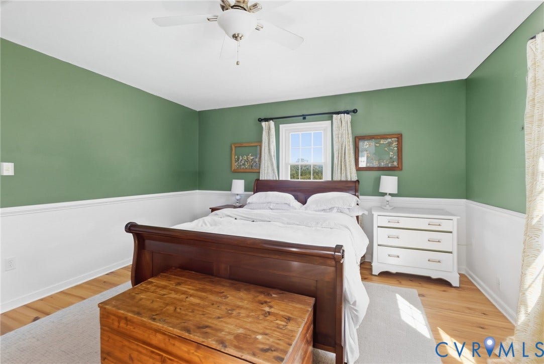 4109 Whitehall Road, Sandy Hook, VA 23153 Hardwood flooring, painted wainscoting, and a ceiling fan with integrated lighting