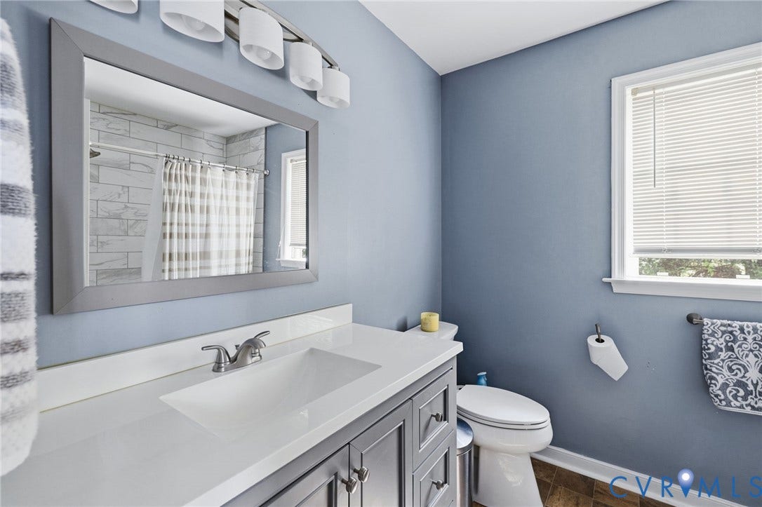 1429 Almondberry Place, Henrico, VA 23231 Vanity with integrated sink, brushed nickel faucet, large framed mirror, and a window with blinds