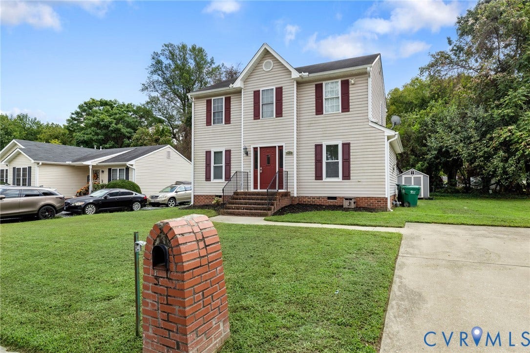 1429 Almondberry Place, Henrico, VA 23231 Two-story exterior with vinyl siding, a prominent front door, mature landscaping, a brick mailbox, and a storage shed