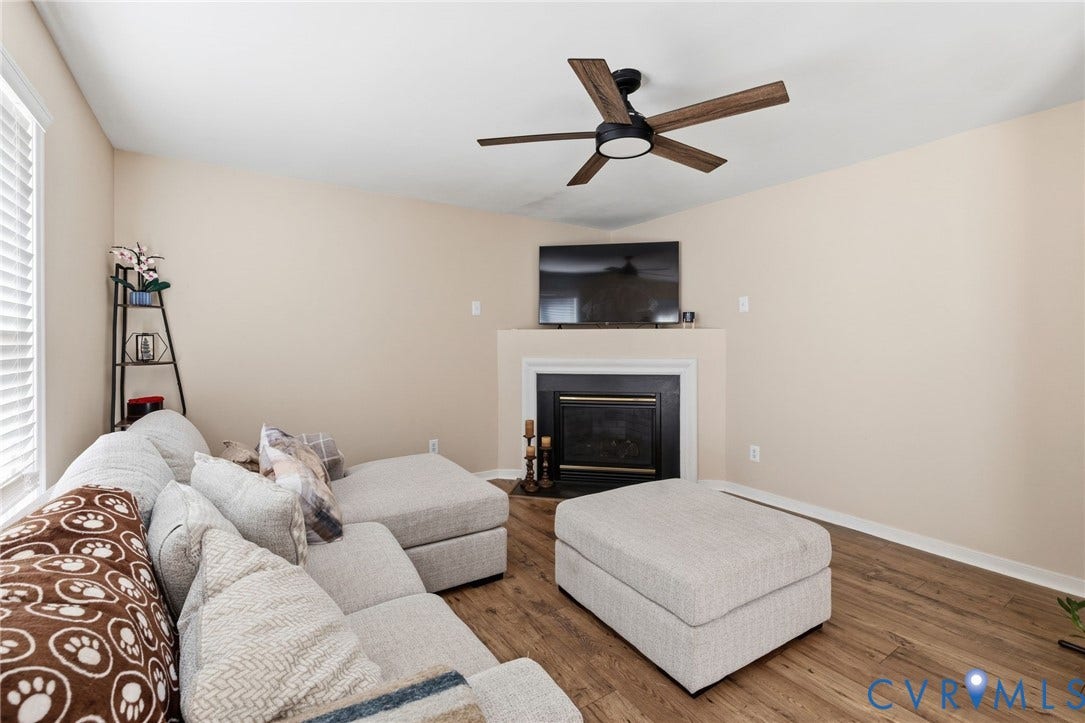 1429 Almondberry Place, Henrico, VA 23231 Fireplace with a white mantel, wood-finish flooring, and a ceiling fan with light fixture