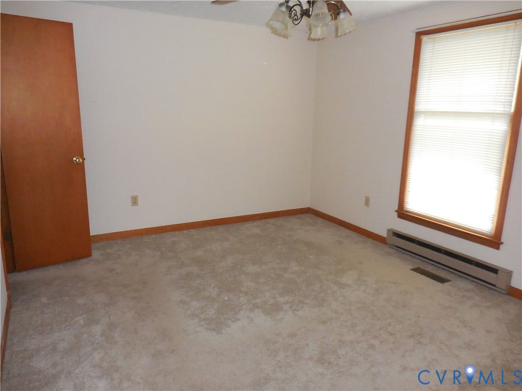 6185 Parrish Road, Louisa, VA 23093 Carpeted flooring with wood trim and a window with blinds