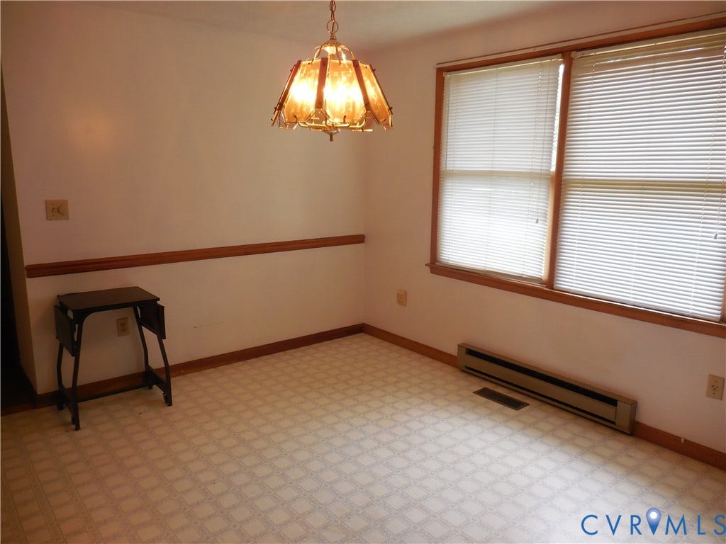 6185 Parrish Road, Louisa, VA 23093 Patterned flooring, dual windows with blinds, wood trim, and an overhead light fixture
