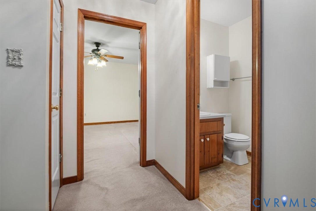 Wood-finish trim details, ceiling fan, carpeted flooring, and tiled flooring