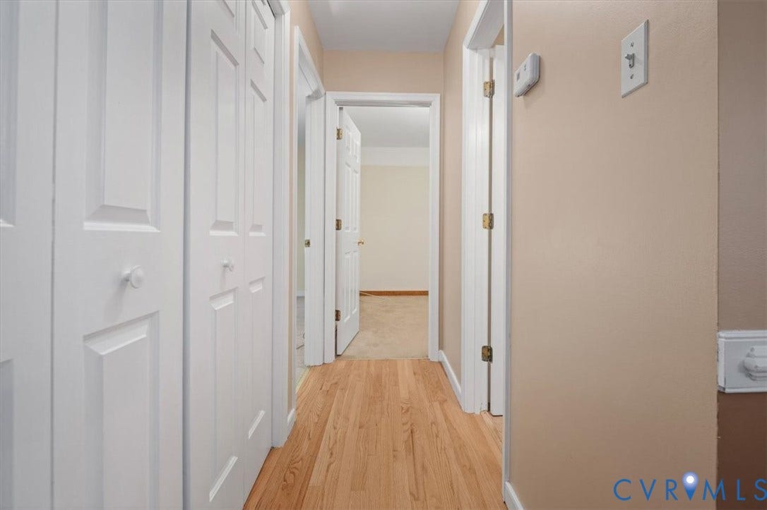 Wood-finish flooring with neutral wall paint and white trim