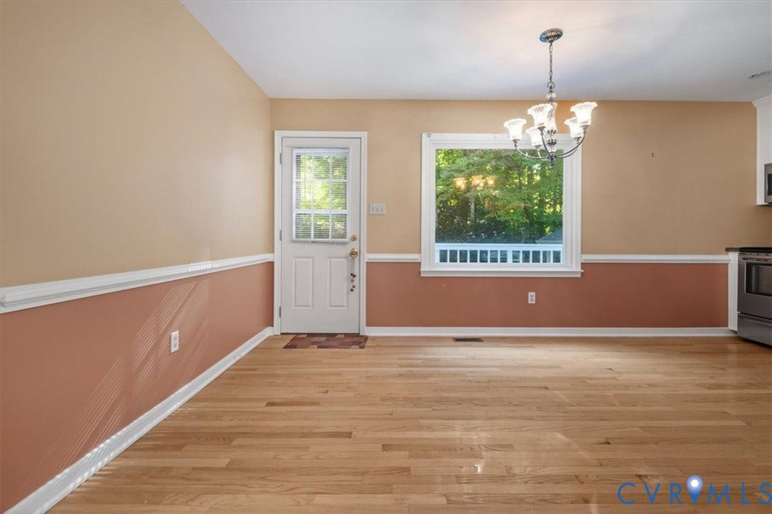 Wood-finish flooring with a multi-pane door and a multi-pane window