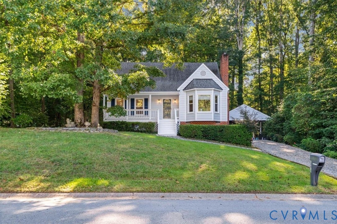Gabled facade with a bay window, a welcoming covered front porch, and a brick chimney
