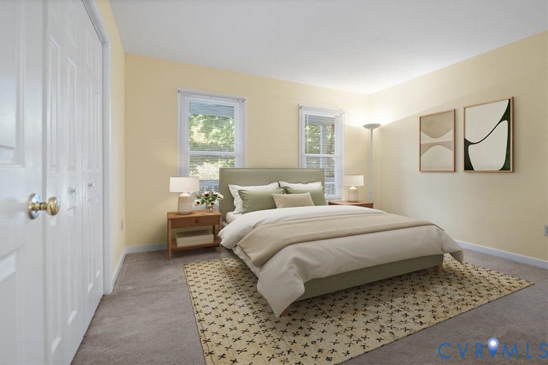 Light-toned walls, carpeted flooring, and a pair of windows allowing natural light