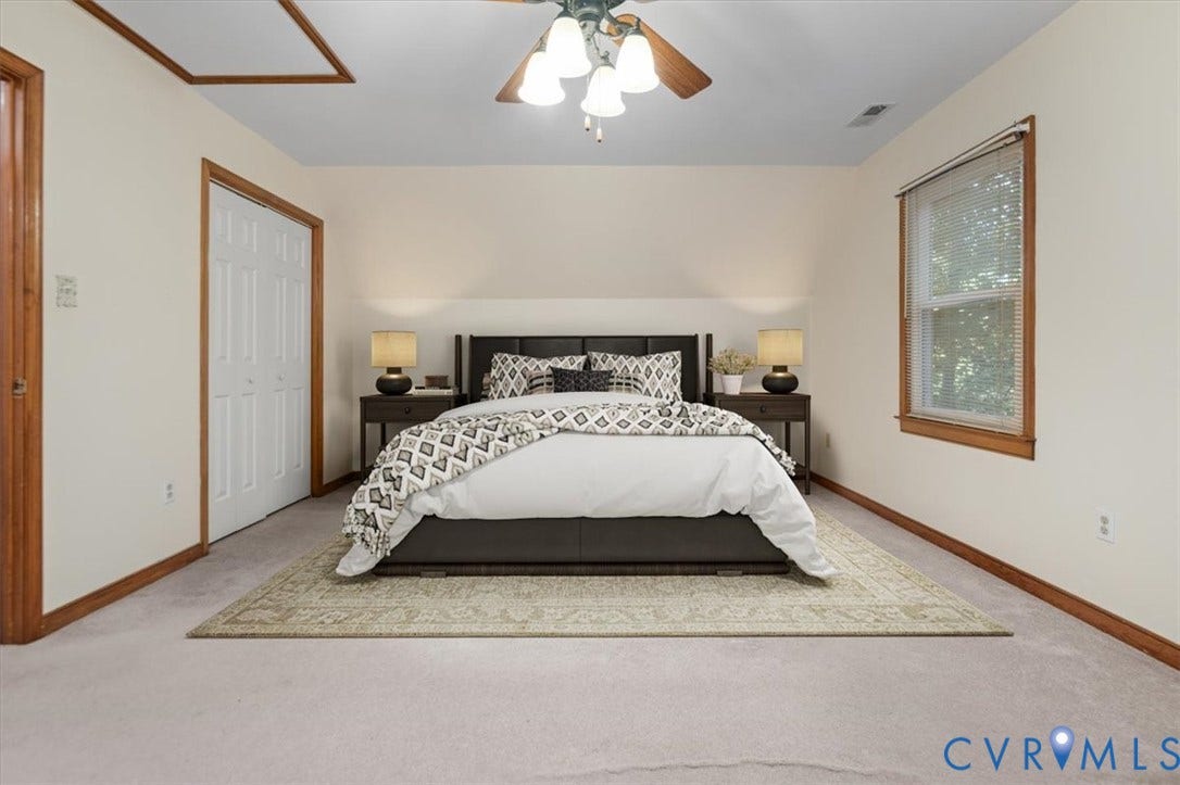 Neutral-toned wall paint, wood window trim, and a ceiling fan with integrated lighting