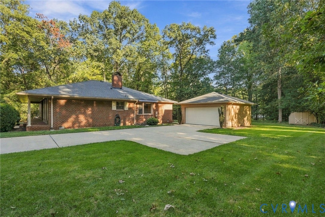 Brick exterior, attached garage, detached garage, concrete driveway, covered porch