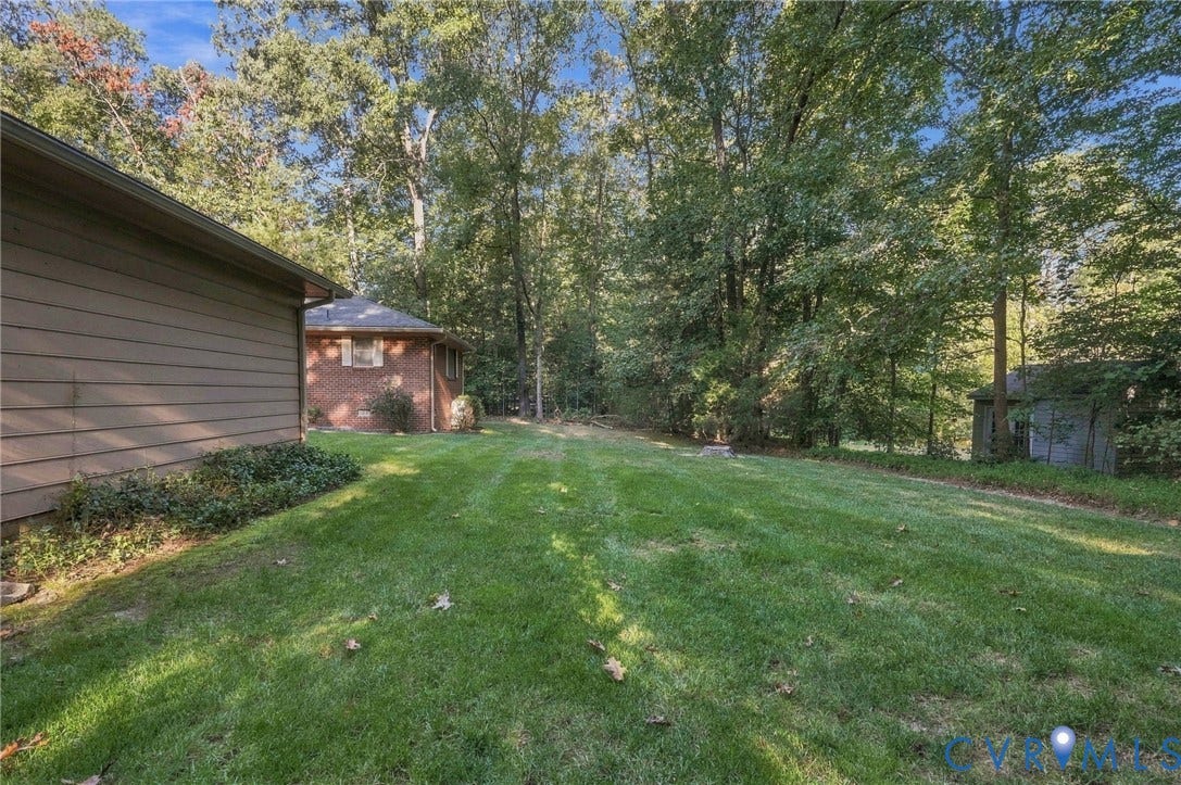 Expansive lawn area bordered by mature trees