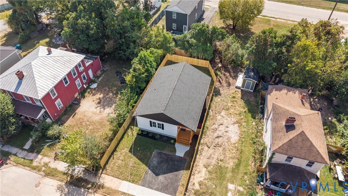 Newly constructed single-story residence with a dark shingle roof and light siding