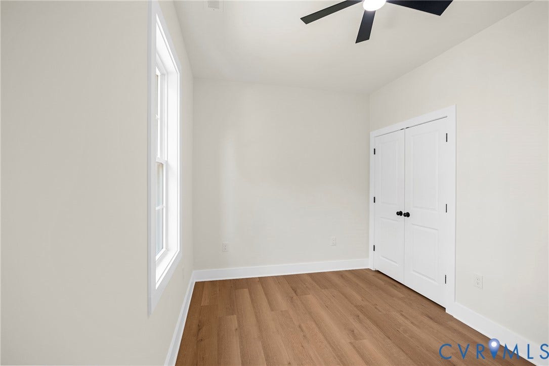Wood-finish flooring, white trim, recessed lighting, and a dark-bladed ceiling fan