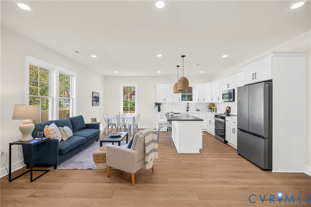 Open-concept living space featuring wood-finish flooring
