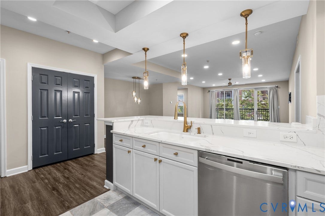4820 Old Main Street, #301, Henrico, VA 23231 Kitchen featuring light grey cabinetry, a gold-finish faucet, stainless steel dishwasher, and white countertops