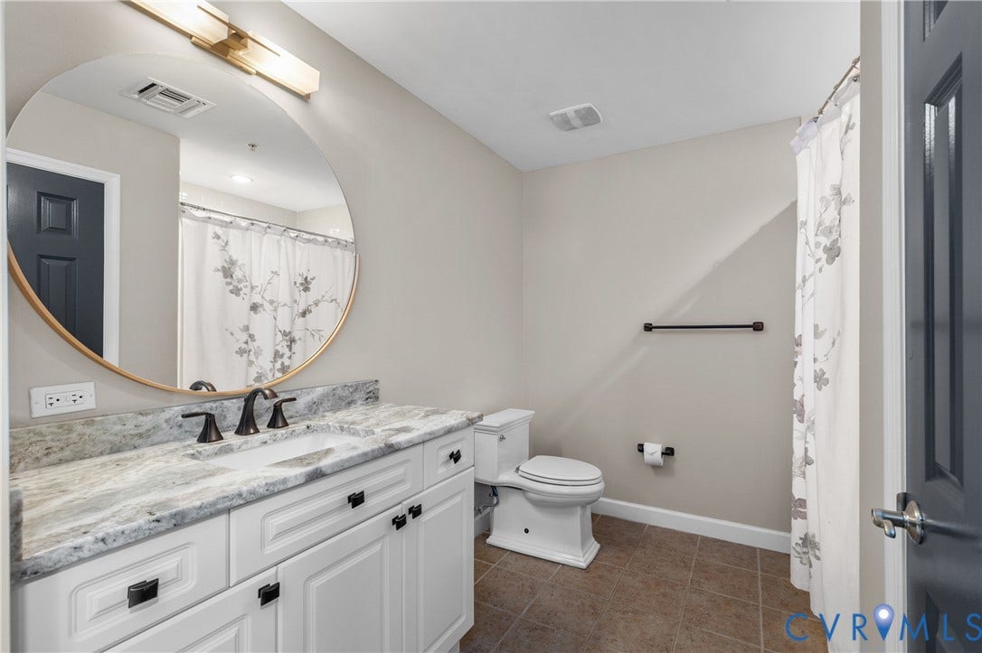 4820 Old Main Street, #301, Henrico, VA 23231 White vanity with undermount sink, granite countertop, and bronze fixtures