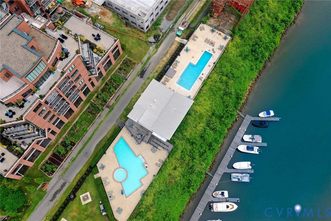 4820 Old Main Street, #301, Henrico, VA 23231 Waterfront property featuring multiple pools, expansive dock space, and lush green landscaping