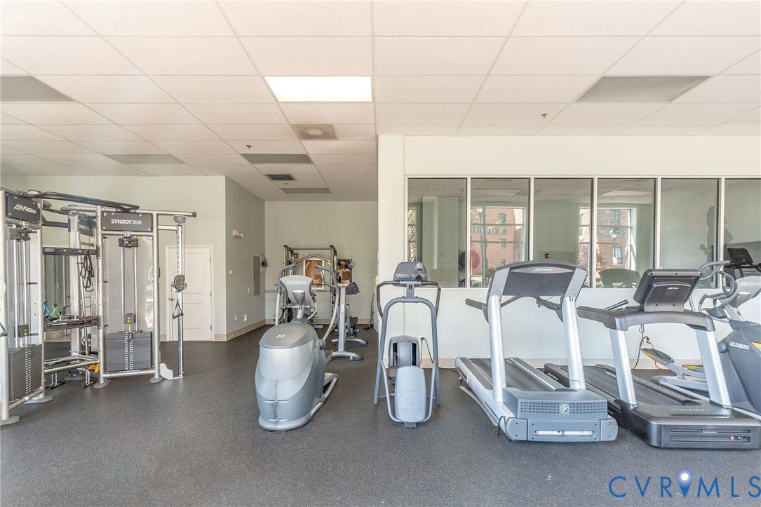 4820 Old Main Street, #301, Henrico, VA 23231 24-hour fitness center featuring cardio equipment, strength training machines, rubber flooring, and large windows.