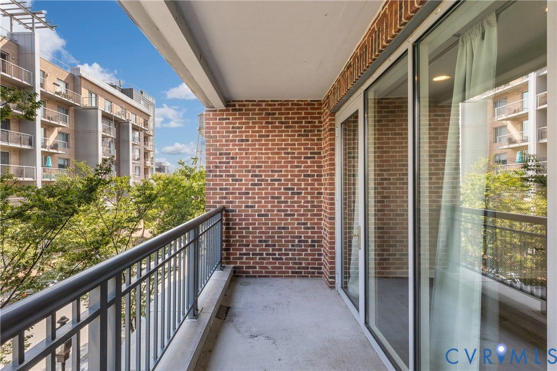 4820 Old Main Street, #301, Henrico, VA 23231 Private balcony featuring a brick wall, metal railing, and sliding glass doors