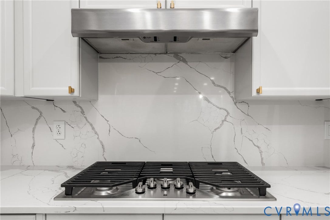4820 Old Main Street, #301, Henrico, VA 23231 Stainless steel range hood and a gas cooktop.