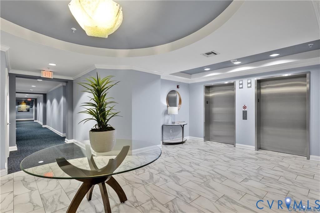 4820 Old Main Street, #301, Henrico, VA 23231 Two stainless steel elevators, marble-patterned floor tiling, recessed lighting, and a tray ceiling with a central light fixture