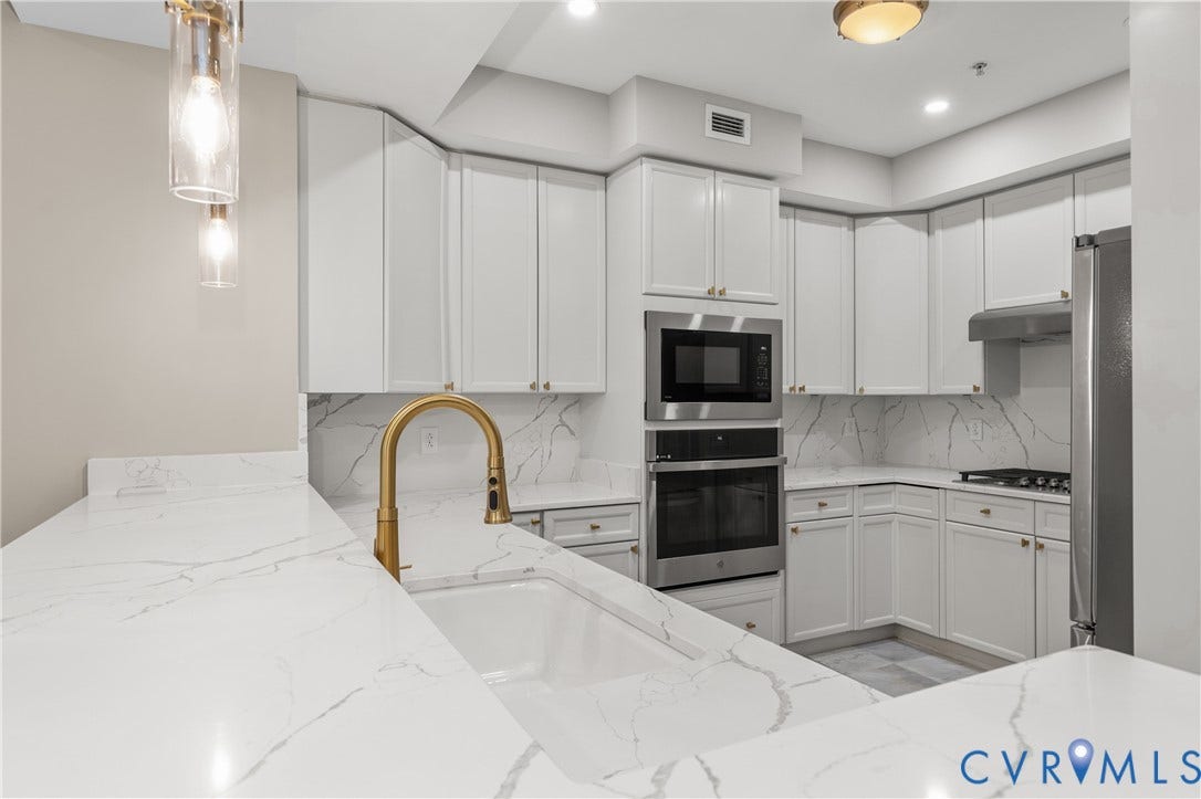 4820 Old Main Street, #301, Henrico, VA 23231 Kitchen has been upgraded with gold finishes, new stainless steel appliance including gas cooktop.