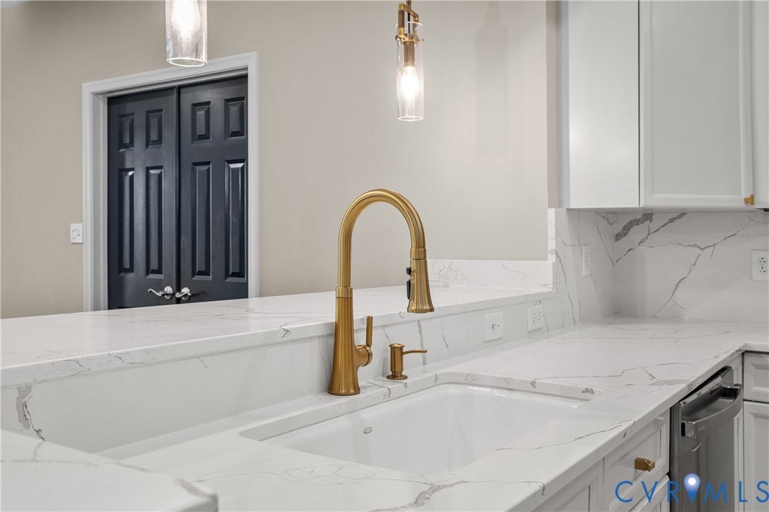 4820 Old Main Street, #301, Henrico, VA 23231 Quartz countertop are white with grey veining, under-mount sink, gold-tone faucet, and RH pendant lighting.