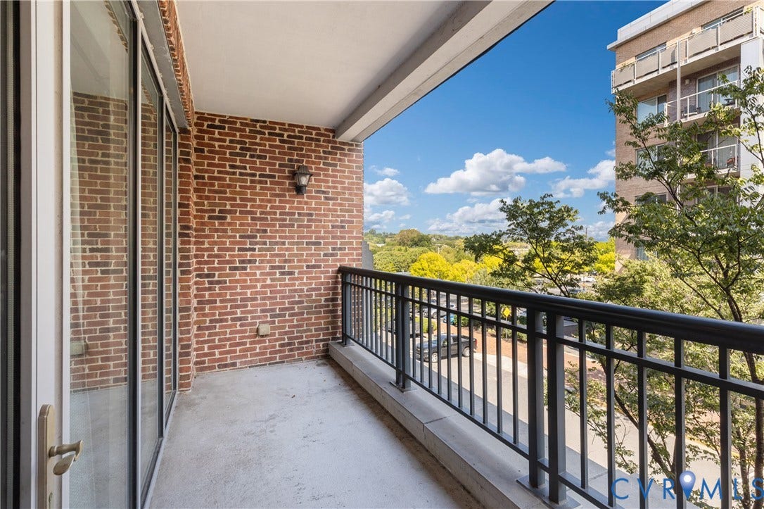 4820 Old Main Street, #301, Henrico, VA 23231 Private balcony featuring a brick exterior wall, concrete flooring, and black metal railings