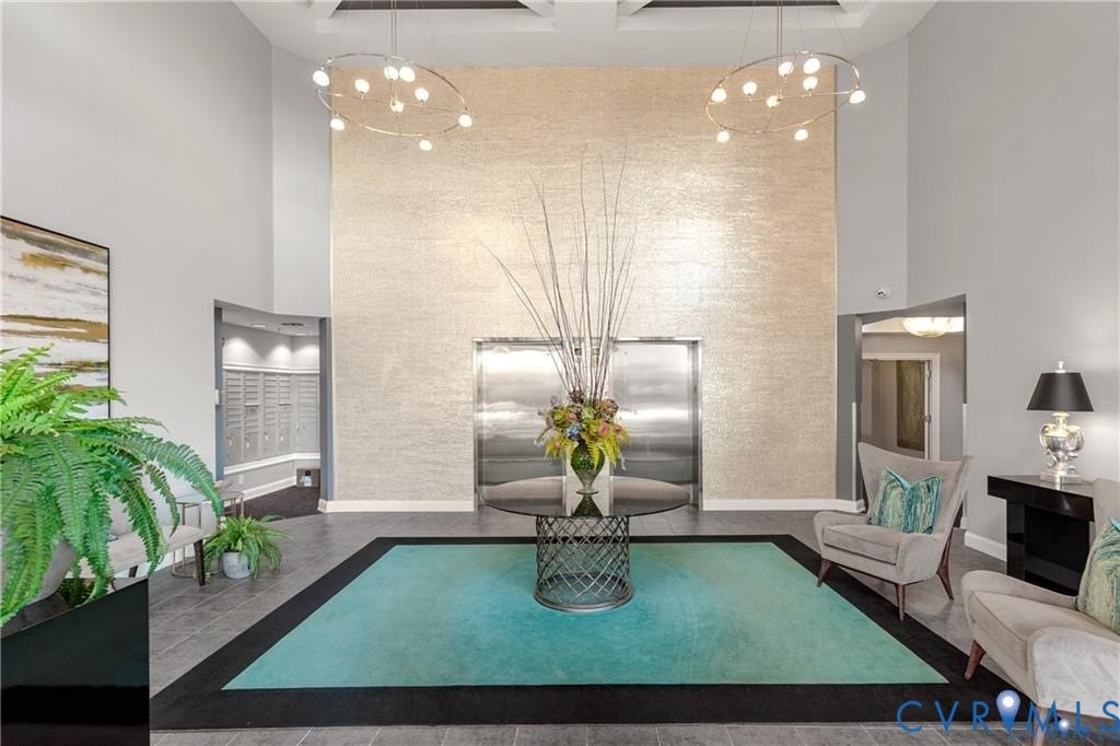 4820 Old Main Street, #301, Henrico, VA 23231 Two-story foyer with a textured accent wall, two contemporary circular chandeliers, and stainless steel elevators