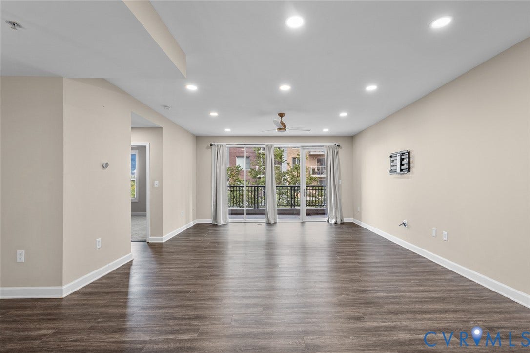 4820 Old Main Street, #301, Henrico, VA 23231 Open-concept living space with wood-finish flooring, recessed lighting, and balcony access