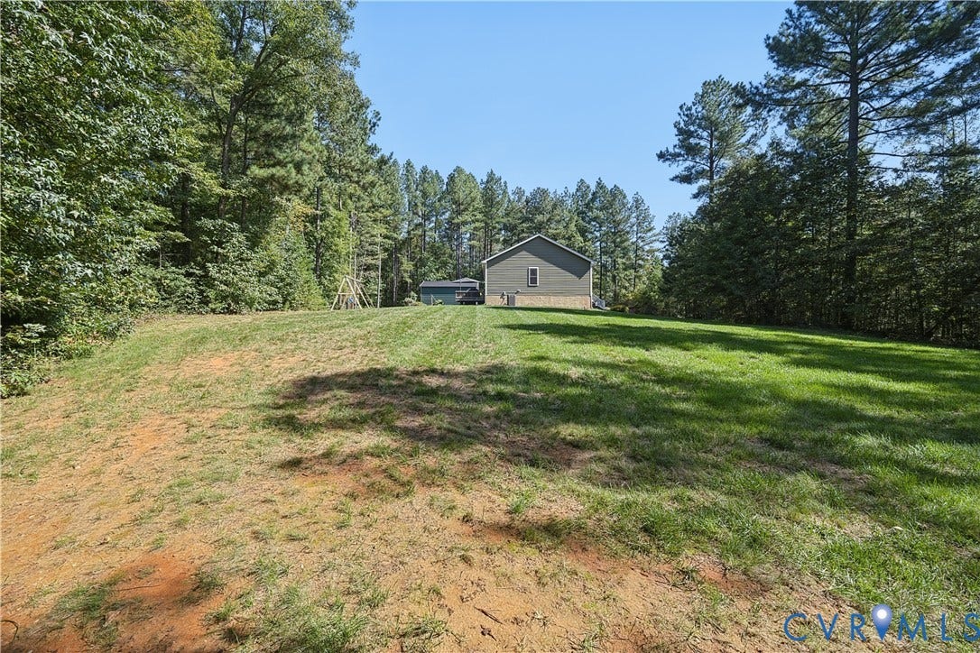 700 Manchester Road, Louisa, VA 23024 Expansive lawn with surrounding mature trees and a detached structure