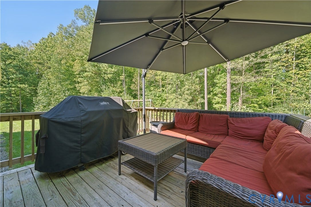 700 Manchester Road, Louisa, VA 23024 Outdoor wooden deck featuring a perimeter railing, surrounded by mature trees