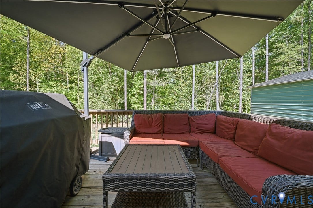 700 Manchester Road, Louisa, VA 23024 Wood deck with a railing, featuring a storage box and a shed