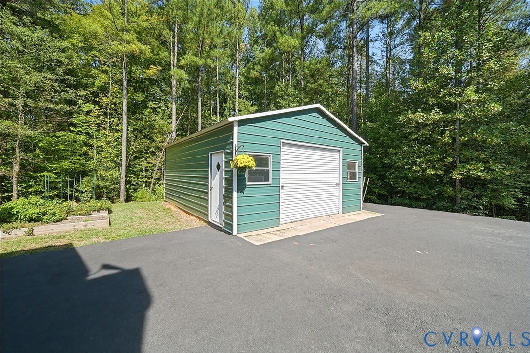 700 Manchester Road, Louisa, VA 23024 Freestanding metal garage with a roll-up door, a side entry door, and two windows