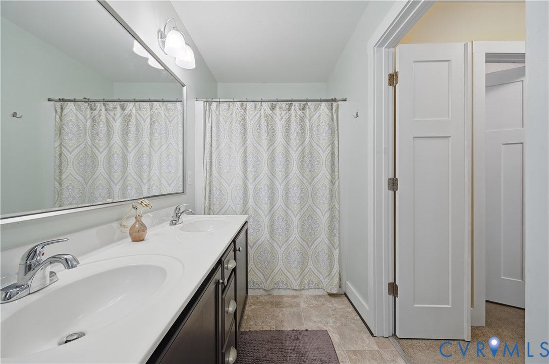700 Manchester Road, Louisa, VA 23024 Dual vanity with undermount sinks, chrome fixtures, and a large mirror