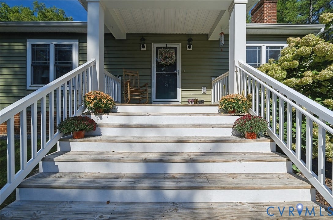 700 Manchester Road, Louisa, VA 23024 Covered front porch entry with white baluster railings and wood-finish steps