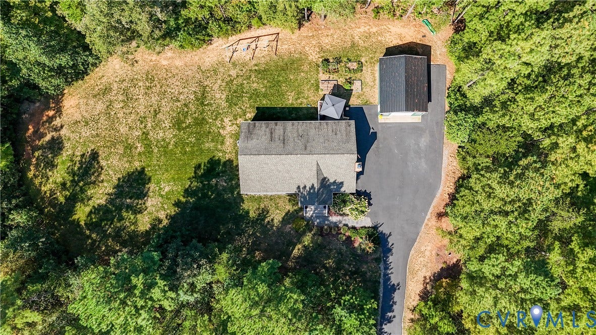 700 Manchester Road, Louisa, VA 23024 Expansive property featuring a paved driveway, detached structure, and lush surrounding trees