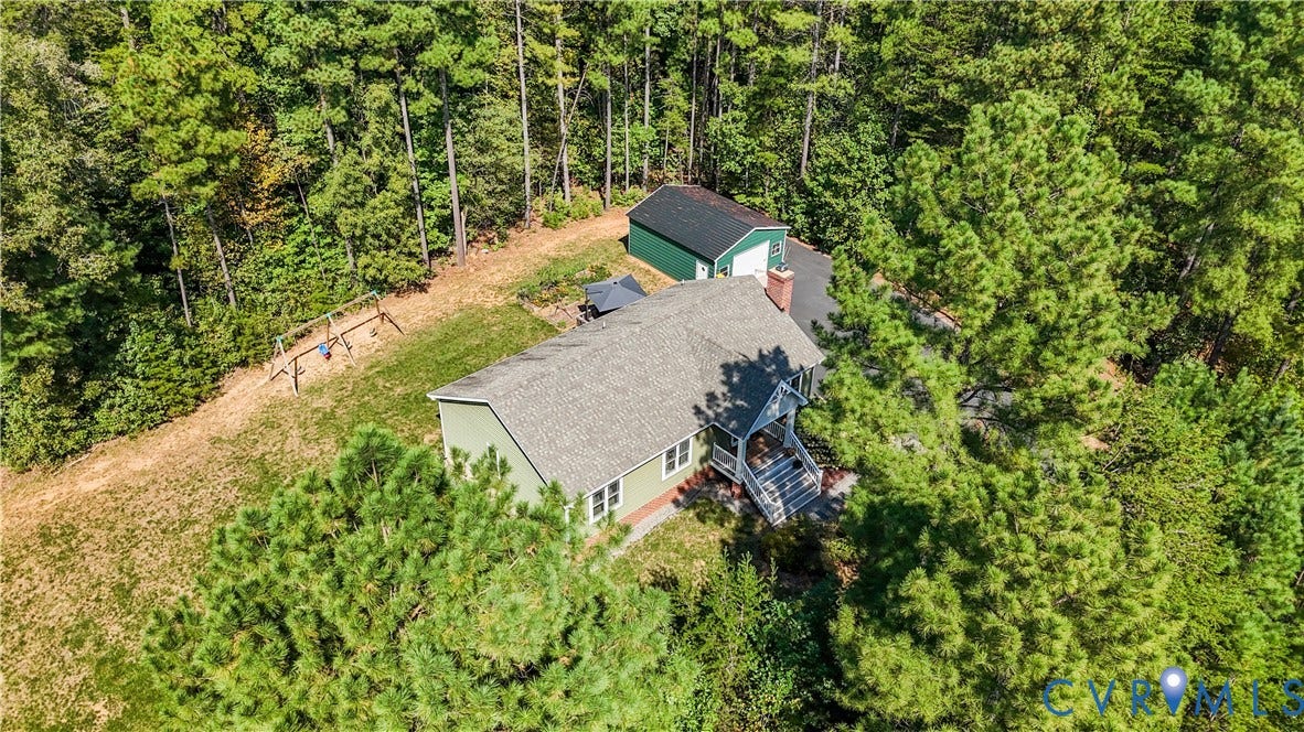 700 Manchester Road, Louisa, VA 23024 Green-sided residence with an attached covered porch, a prominent chimney, and a dark shingle roof