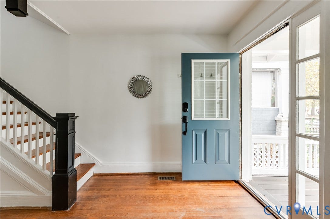2224 Seminary Avenue, Richmond, VA 23220 Hardwood flooring, painted paneled door with window inserts, white walls, dark wood newel post, and white balusters
