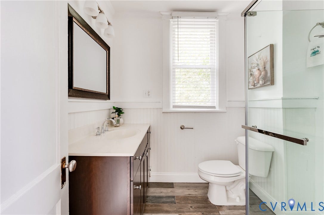 2224 Seminary Avenue, Richmond, VA 23220 Vanity with a light-toned countertop, wood-finish flooring, and a glass-enclosed shower