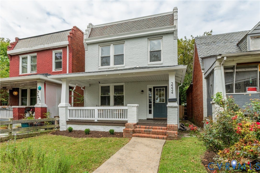 2224 Seminary Avenue, Richmond, VA 23220 Brick exterior with light gray paint, covered front porch, white railing, brick steps, and a landscaped front yard