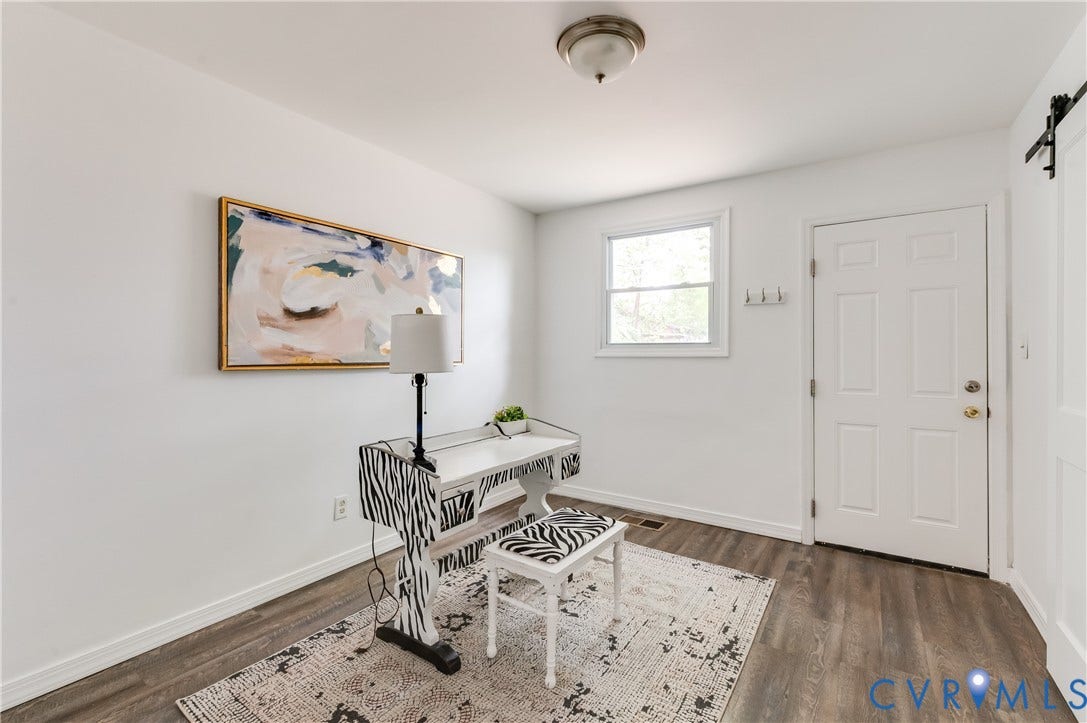 2224 Seminary Avenue, Richmond, VA 23220 Recessed window, wood-finish flooring, white paneled door, flush-mount ceiling light, and barn door hardware