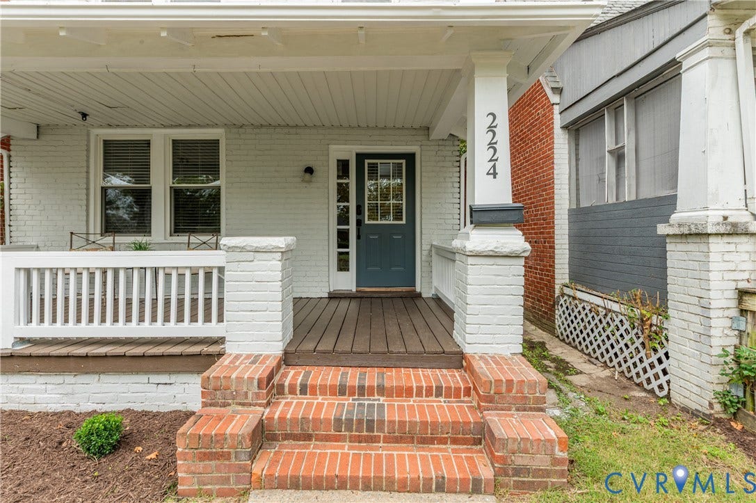 2224 Seminary Avenue, Richmond, VA 23220 Front porch featuring a dark wood-finish deck, white railing, and brick steps
