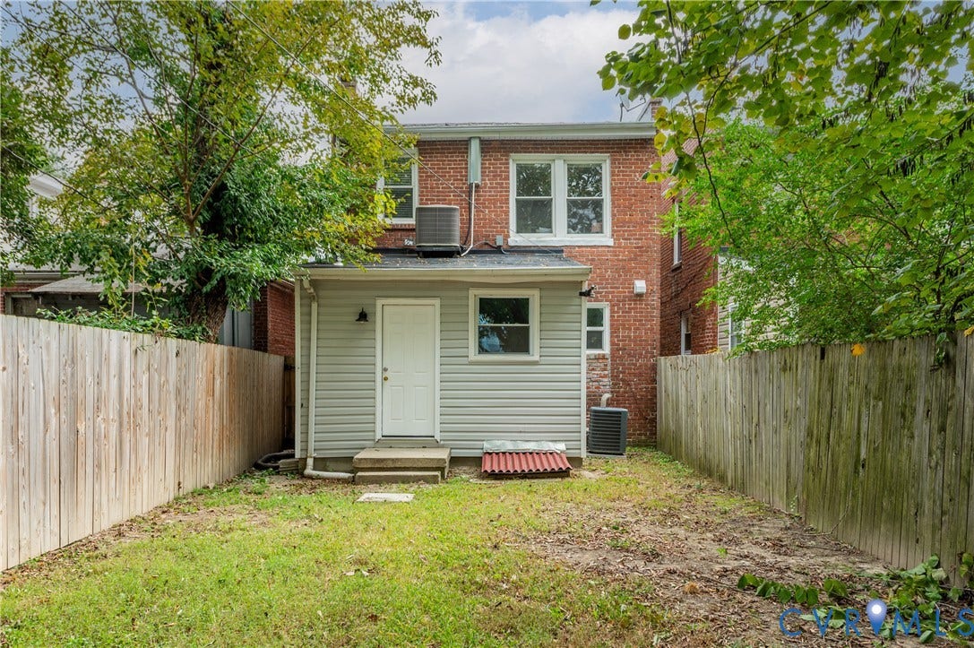 2224 Seminary Avenue, Richmond, VA 23220 Fenced backyard featuring a brick exterior, light-colored siding, and mature perimeter trees