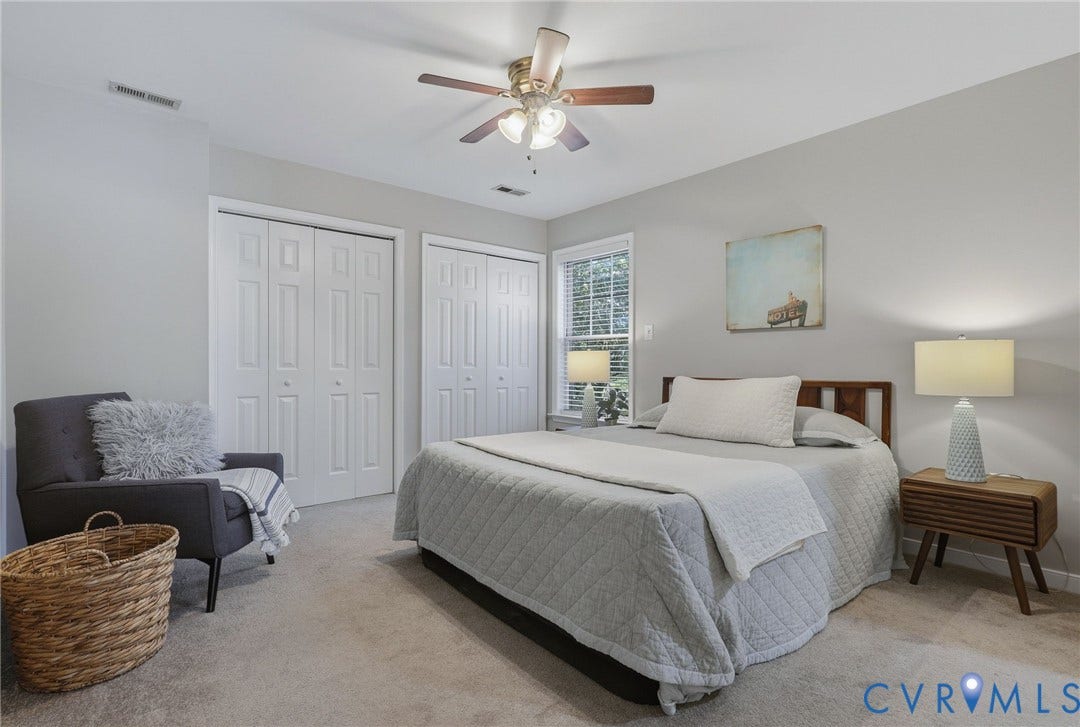 932 Ayers Way, Ayers Tavern, Glen Allen, VA 23060 Soft gray wall tones, ceiling fan with integrated lighting, wood headboard, two white bi-fold closet doors, and natural light from a window with blinds